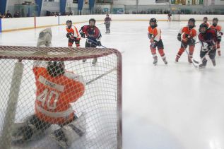 Atom Flyers goalie Tyson Young snapped the trapper on this one that was headed for glove-side high.